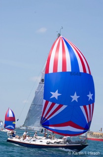 Sailboat with red, white and blue spinnakers at start of Race to Mackinac